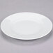 A 10 Strawberry Street Classic White porcelain salad/dessert plate with a rim on a gray surface.