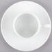 A 10 Strawberry Street Classic White porcelain espresso cup and saucer on a white surface.