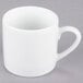 A white 10 Strawberry Street porcelain espresso cup with a saucer and a handle.