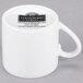 A white porcelain espresso cup with a handle and saucer.