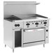 A large stainless steel Wolf commercial range with 2 burners, a griddle, and a standard oven.