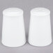 A close-up of two white 10 Strawberry Street salt and pepper shakers.
