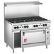 A large stainless steel Wolf commercial range with 8 burners and a standard oven.