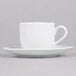 A 10 Strawberry Street white porcelain espresso cup and saucer with a white surface.