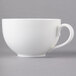 A close-up of a 10 Strawberry Street white porcelain coffee cup with a handle.