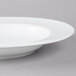 A white 10 Strawberry Street porcelain soup bowl with a rim.