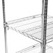 A silver metal rack with a shelf on top.