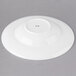 A white round porcelain bowl with a rim.