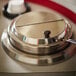 A close up of a Vollrath stainless steel decorative ring.