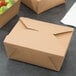 Two brown Fold-Pak Bio-Plus Earth take-out boxes on a table.