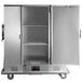 A large silver metal Metro heated banquet cabinet with an open door.