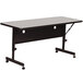 A gray rectangular Correll seminar table with wheels.