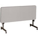 A gray rectangular table with wheels.