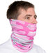 A man wearing a pink and grey camo Headsweats bandana over his face.