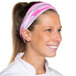 A woman wearing a pink and white Headsweats headband.