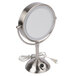 A round silver Conair freestanding LED lighted vanity mirror with a cord and white cover.