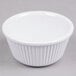 A close-up of a white Thunder Group fluted melamine ramekin.