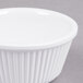 A white fluted Thunder Group ramekin.