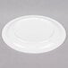 A Carlisle white polycarbonate plate with a narrow rim on a gray surface.