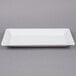 A white rectangular American Metalcraft stoneware platter with a white rectangular plate on it.