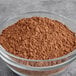 A glass bowl of HERSHEY'S Natural Cocoa Powder.