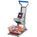 An Edlund ARC! 1/4" pusher head assembly slicing onions with a vegetable slicer.