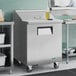 A True refrigerated sandwich prep table with a stainless steel counter top.