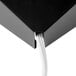 A close-up of a black Curtron Insect Trap Wall Sconce box with a white cable attached to it.