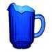 A cobalt blue Vollrath Traex plastic pitcher with a handle.