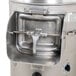 A close-up of the Hobart 6115 countertop potato peeler, a stainless steel machine with a metal container and a handle.