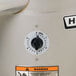 A close up of the dial on a Hobart countertop potato peeler with numbers on it.