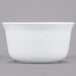 A white bowl on a gray surface.