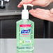 A bottle of Purell Advanced hand sanitizer with a pump.