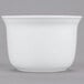 A white Cambro porcelain bowl on a gray surface.