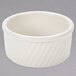 A white Tuxton eggshell swirl ramekin.