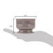 A hand holding a Cambro Shoreline Collection wheat bowl.