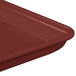 A MFG Tray burgundy fiberglass market display tray on a table.