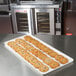 A MFG Tray Supreme Display Tray of cookies on a counter in a bakery display.