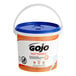 A white bucket of GOJO Fast Towels with a blue lid.