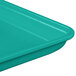 A mint green MFG Tray market and bakery display tray on a table.