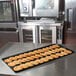 A black MFG Fiberglass Supreme Display Tray holding cookies on a counter.