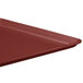 A close-up of a burgundy MFG Tray rectangular display tray.