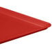 A red MFG Tray Supreme display tray on a table.