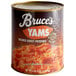 A case of 6 Bruce's #10 cans of mashed sweet potatoes on a table in a grocery store aisle.