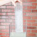 A hand placing a clear rectangular container with ice inside into a Cal-Mil beverage dispenser.