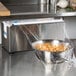 A bowl of noodles wrapped in plastic on a counter.