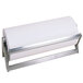 A roll of paper on a stainless steel metal paper cutter.