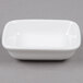 A white rectangle Tuxton China sauce dish.