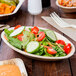 A vegetable salad in an EcoChoice palm leaf bowl on a table.