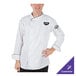 A man wearing a white Mercer Culinary chef jacket with black piping.